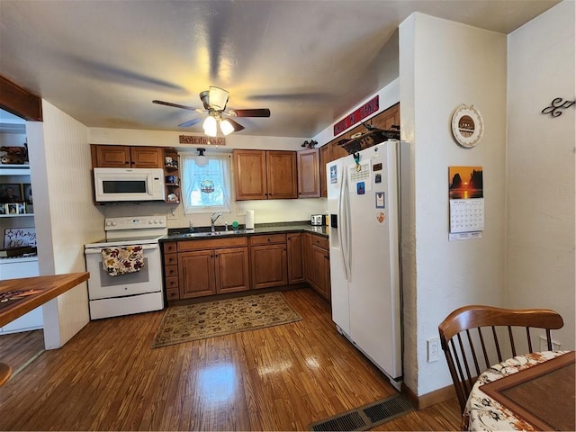 kitchen featuring sink, dark hardwood / wood-style flooring, white appliances, and ceiling fan