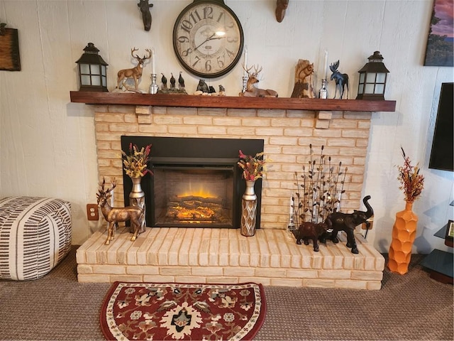 room details featuring a brick fireplace and carpet floors