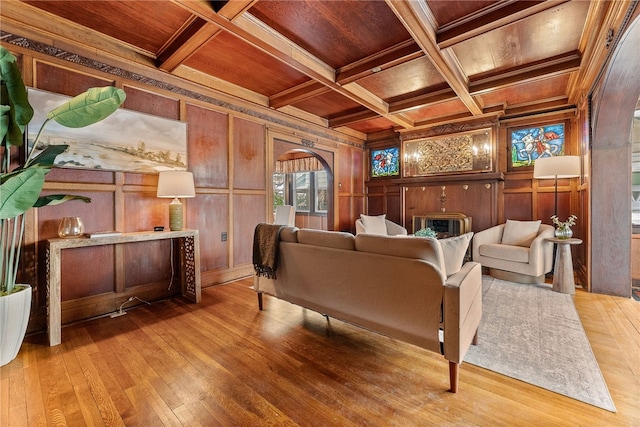 interior space with wood ceiling, coffered ceiling, crown molding, beamed ceiling, and wooden walls