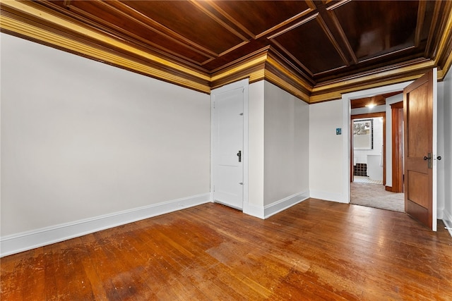 unfurnished room with coffered ceiling, hardwood / wood-style flooring, ornamental molding, and wooden ceiling