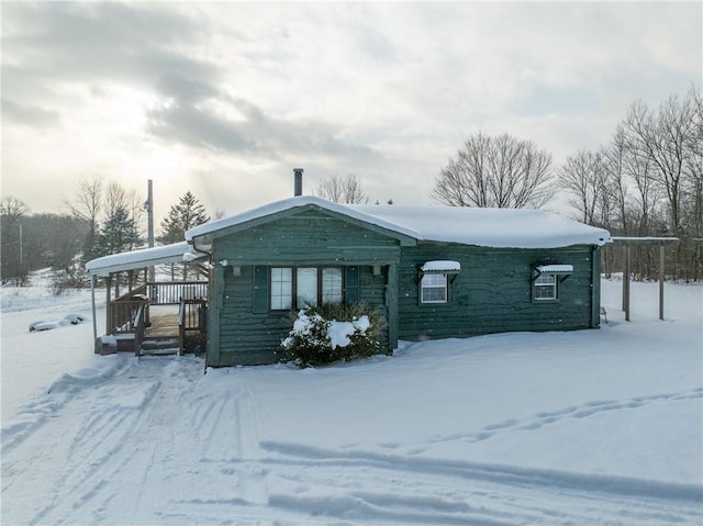 view of snow covered back of property