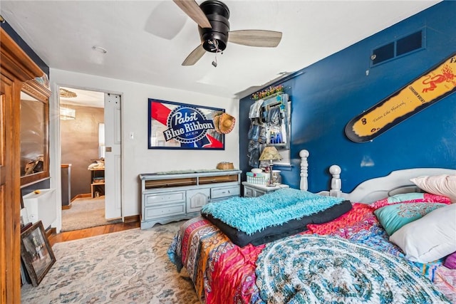 bedroom with ceiling fan and hardwood / wood-style floors