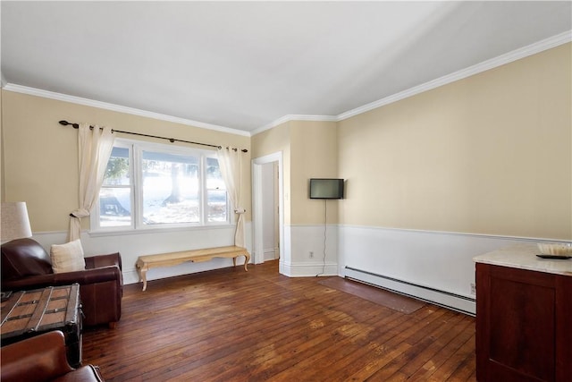 sitting room featuring a baseboard heating unit, dark wood-type flooring, and crown molding