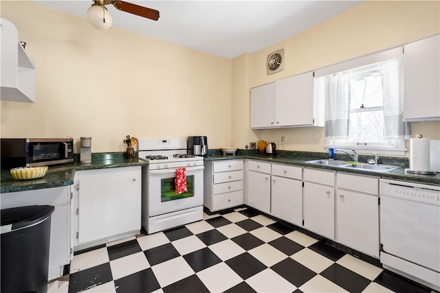 kitchen with white appliances, ceiling fan, white cabinets, and sink