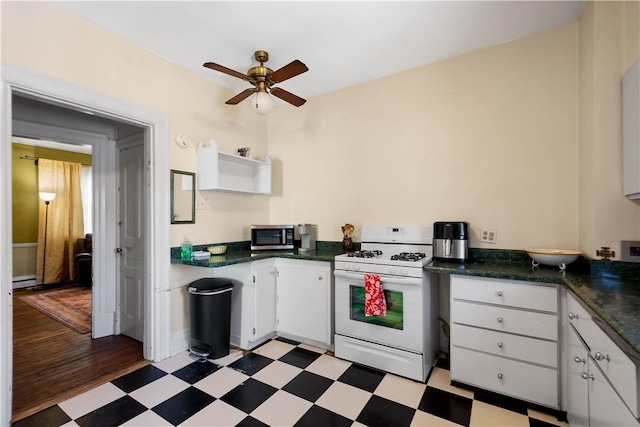 kitchen with white cabinets, white range with gas cooktop, and ceiling fan