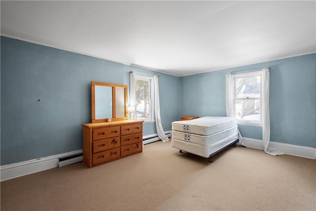 carpeted bedroom featuring baseboard heating and multiple windows