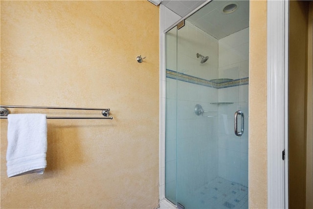 bathroom with a shower with shower door