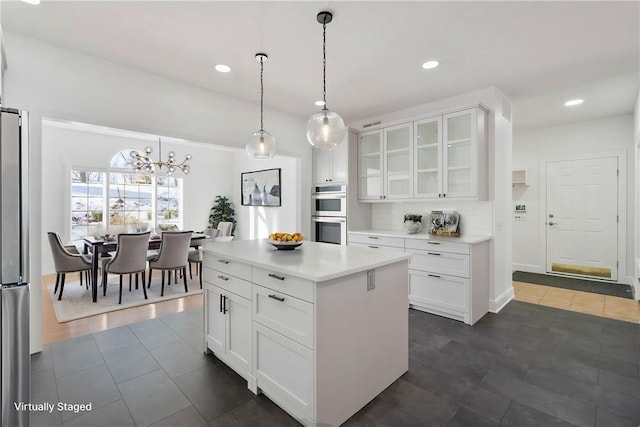 145 Cedar Rdg, Center Twp But, PA 16001 - kitchen featuring stainless steel appliances, white cabinetry, light countertops, glass insert cabinets, and recessed lighting