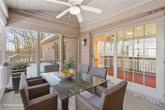 sunroom featuring ceiling fan, a wealth of natural light, lofted ceiling, and wood ceiling