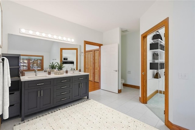 145 Cedar Rdg, Center Twp But, PA 16001 - bathroom featuring toilet, double vanity, baseboards, and a closet