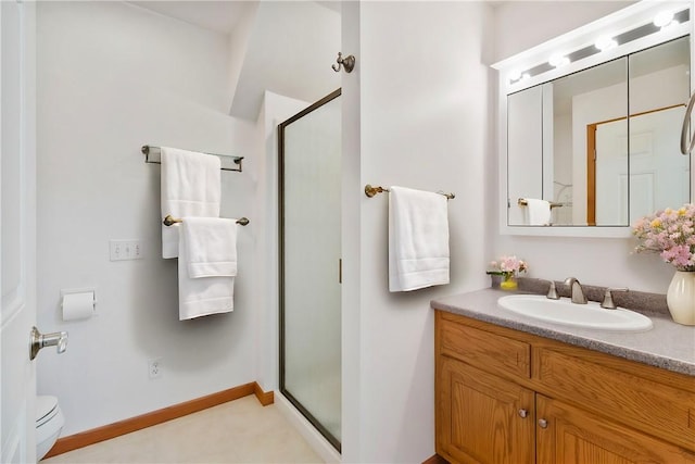 bathroom featuring a shower with door and vanity