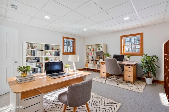 carpeted office featuring a paneled ceiling