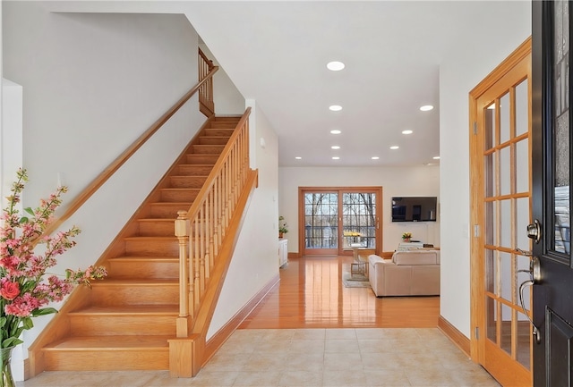 tiled foyer with recessed lighting, stairway, and baseboards