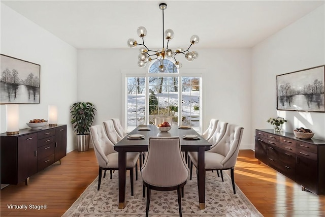 dining room featuring light hardwood / wood-style floors and a notable chandelier