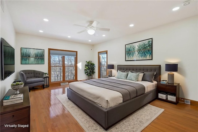 bedroom with ceiling fan and light hardwood / wood-style floors