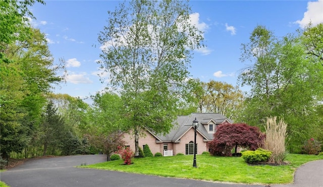 145 Cedar Rdg, Center Twp But, PA 16001 - view of front of home featuring stucco siding, a front yard, and asphalt driveway