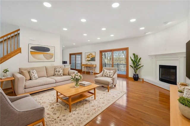 145 Cedar Rdg, Center Twp But, PA 16001 - living room with light wood-type flooring, recessed lighting, stairs, a glass covered fireplace, and baseboards