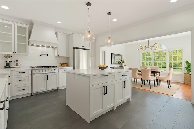 145 Cedar Rdg, Center Twp, PA 16001 - kitchen with premium range hood, stainless steel refrigerator, decorative backsplash, white cabinetry, and light countertops