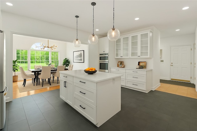 145 Cedar Rdg, Center Twp, PA 16001 - kitchen featuring white cabinetry, glass insert cabinets, light countertops, hanging light fixtures, and recessed lighting