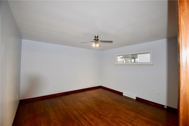 unfurnished room with dark hardwood / wood-style flooring and ceiling fan