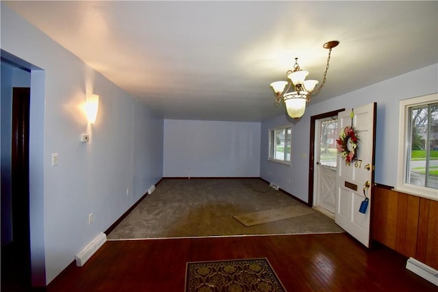 entrance foyer featuring a notable chandelier and dark hardwood / wood-style floors