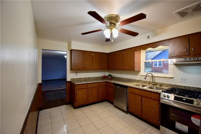 kitchen with stainless steel appliances, light tile patterned floors, sink, and ceiling fan