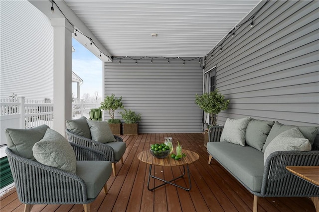 wooden terrace featuring an outdoor living space