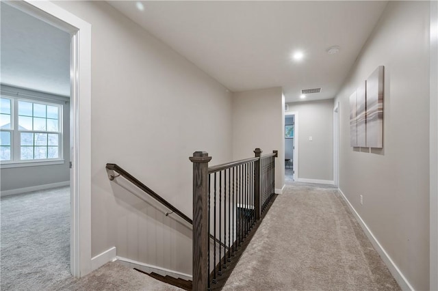 stairway featuring carpet flooring