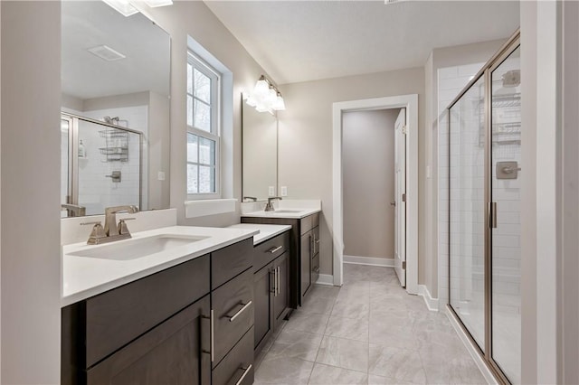 bathroom with vanity and a shower with shower door