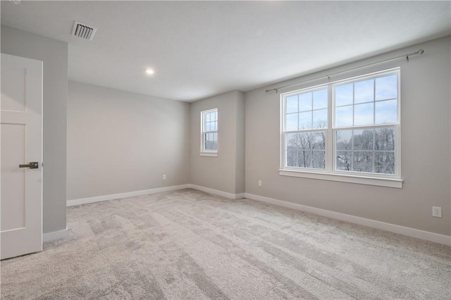 unfurnished room featuring light carpet