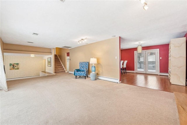 unfurnished room featuring baseboard heating and hardwood / wood-style floors