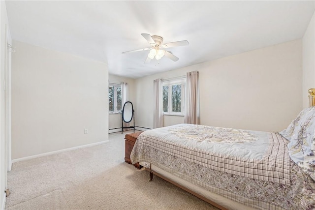 bedroom with ceiling fan, baseboard heating, and light carpet