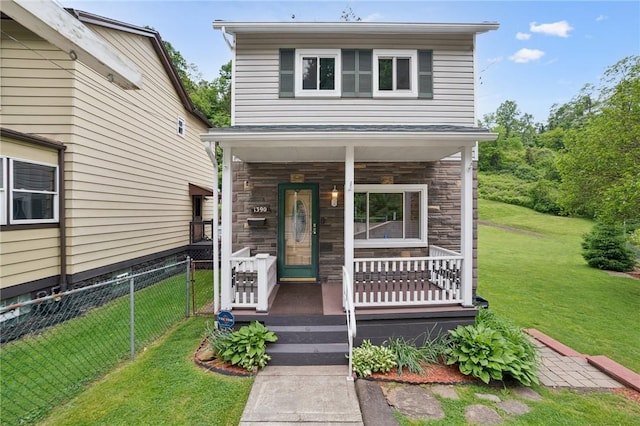 view of front of property with a porch and a front lawn