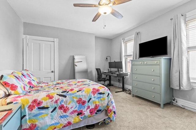 bedroom featuring ceiling fan and light carpet