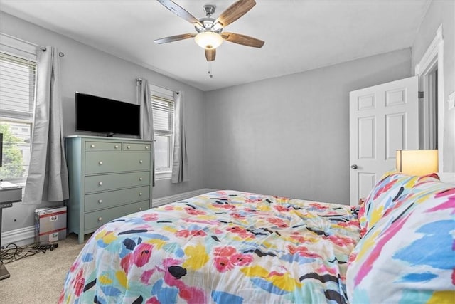 bedroom with ceiling fan and light colored carpet