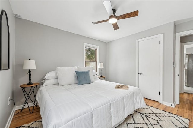 bedroom with ceiling fan and light hardwood / wood-style flooring