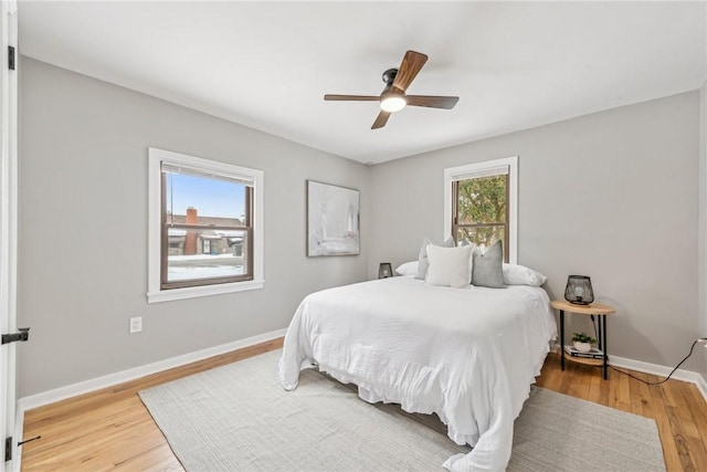 bedroom with ceiling fan and hardwood / wood-style floors