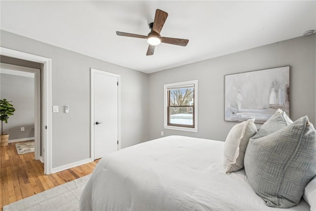 bedroom with light wood-type flooring and ceiling fan