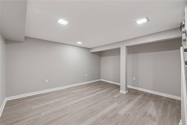 basement with light hardwood / wood-style floors