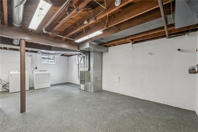 basement with separate washer and dryer and heating unit