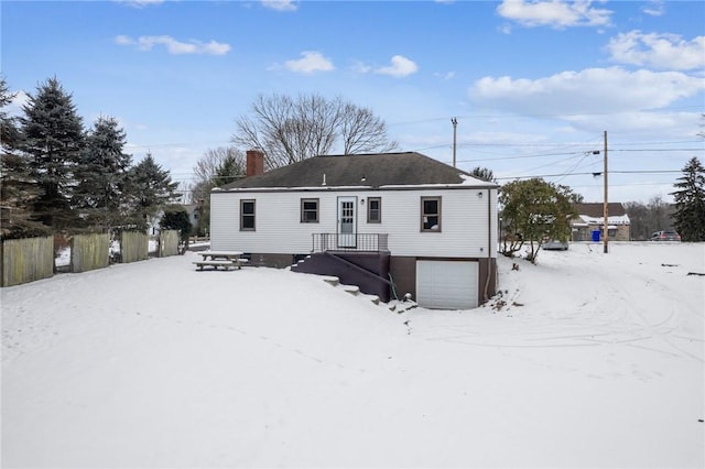 snow covered property featuring a garage