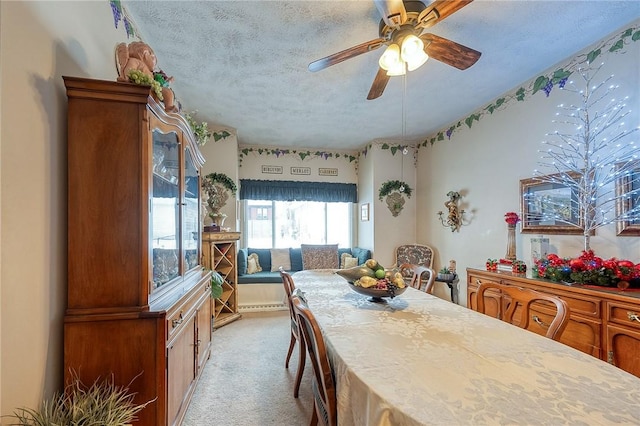 carpeted dining space featuring a textured ceiling, ceiling fan, and a baseboard radiator