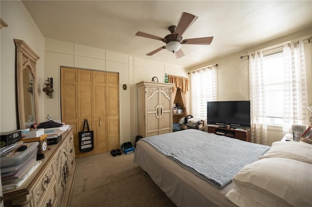 bedroom with a closet, ceiling fan, and light colored carpet