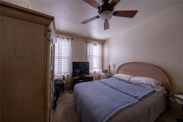 bedroom featuring ceiling fan and light carpet