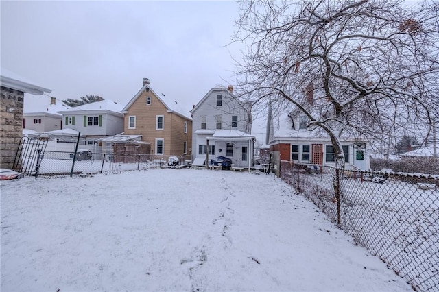 view of snow covered back of property