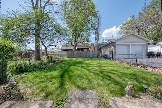 view of yard with a garage and a fenced backyard