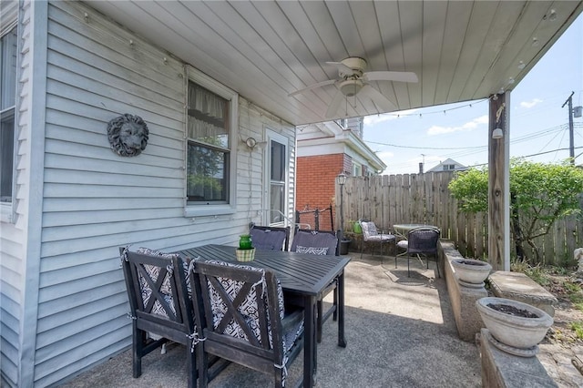 view of patio featuring ceiling fan, fence, and outdoor dining space