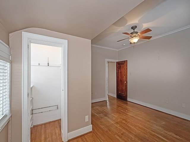 unfurnished bedroom with light wood-type flooring, ceiling fan, and crown molding