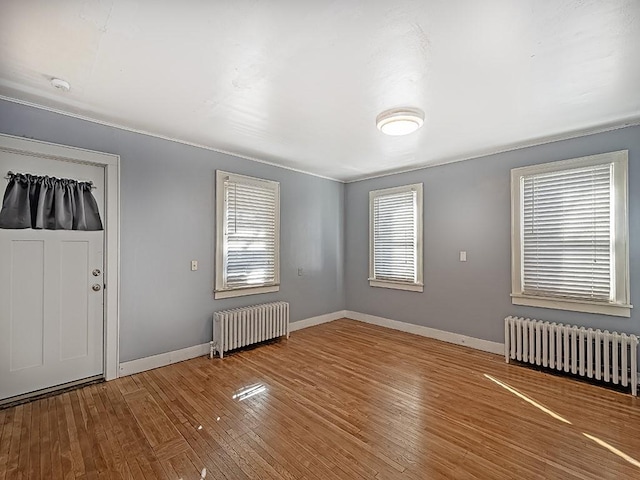 foyer with wood-type flooring and radiator