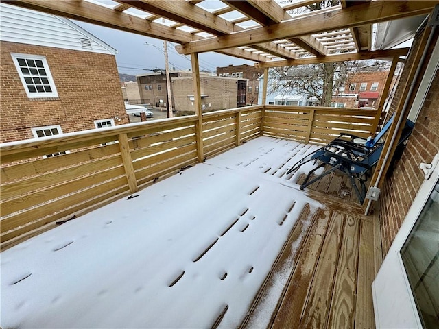 snow covered deck featuring a pergola